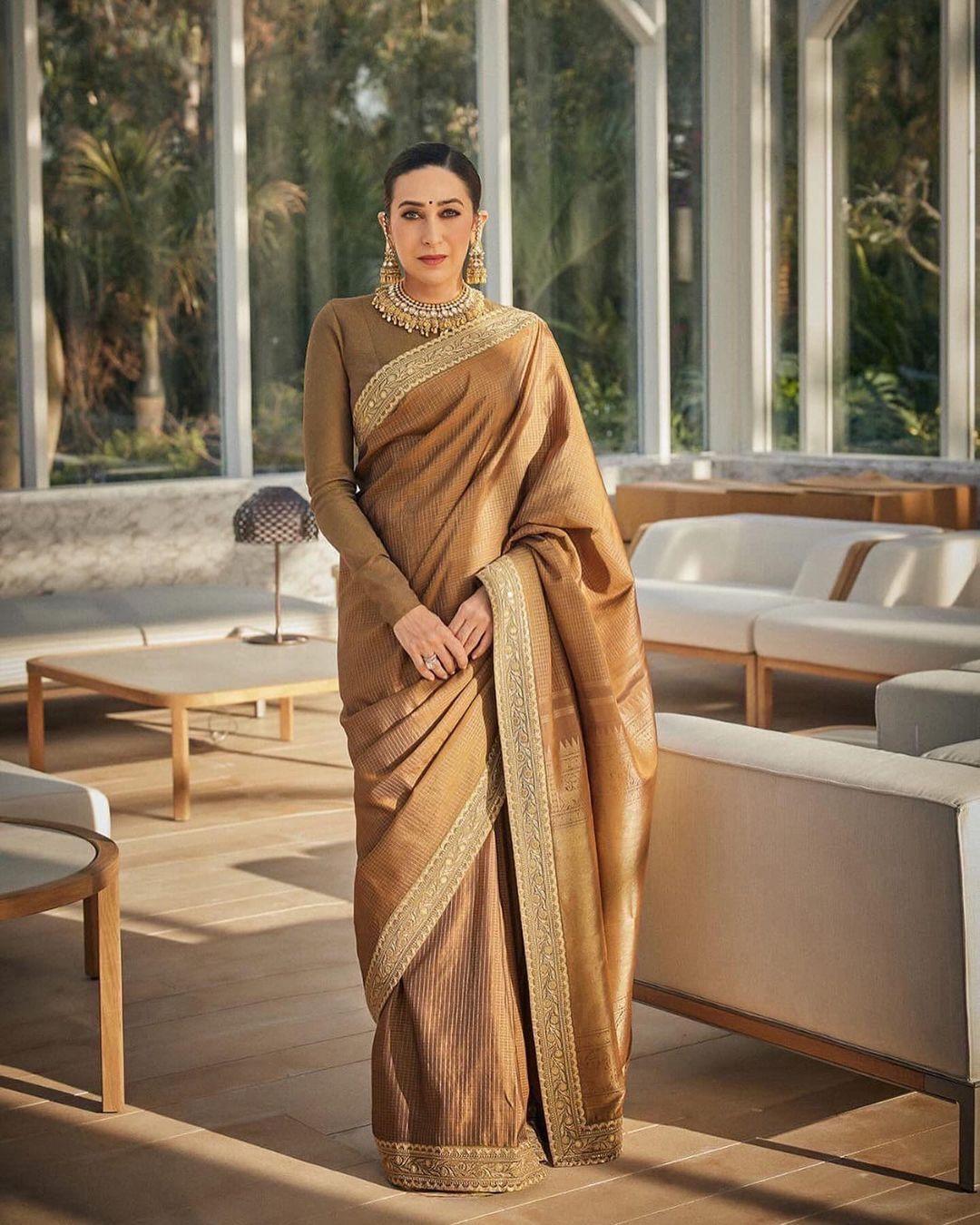 Styled by Vrinda Narang, Karisma Kapoor wore a chic checkered and striped silk saree adorned with intricate gold floral embroidery along the edges.