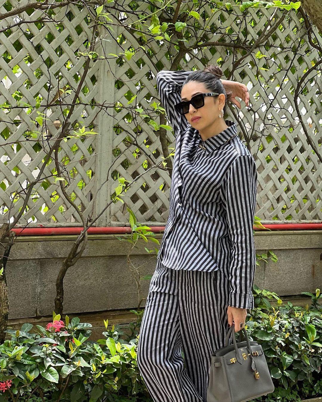 The outfit included a full-sleeved button-down shirt and straight-fit pants in black and grey, paired with white sneakers, making it perfect for a sunny city afternoon. 
