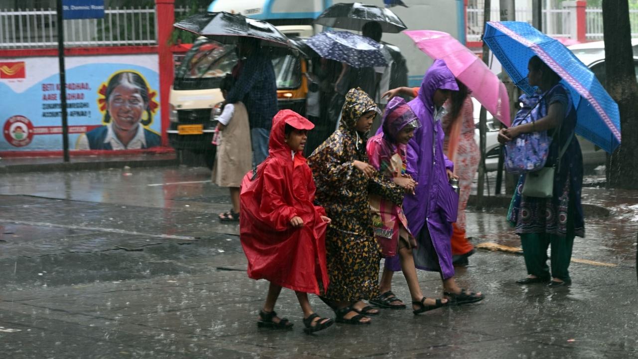 People were seen bearing umbrellas and clad in raincoats riding two-wheelers or afoot on streets amid the downpour. Those without an umbrella were see either seeking shelter or embracing the heavy showers
