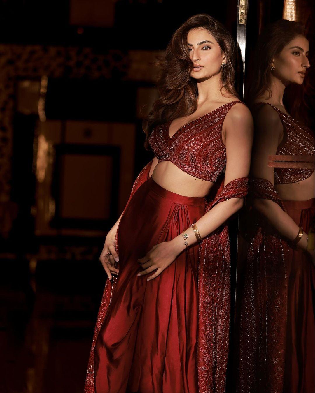 Her uniquely draped red skirt, featuring structured pleats and a gathered design, was both sophisticated and stylish.