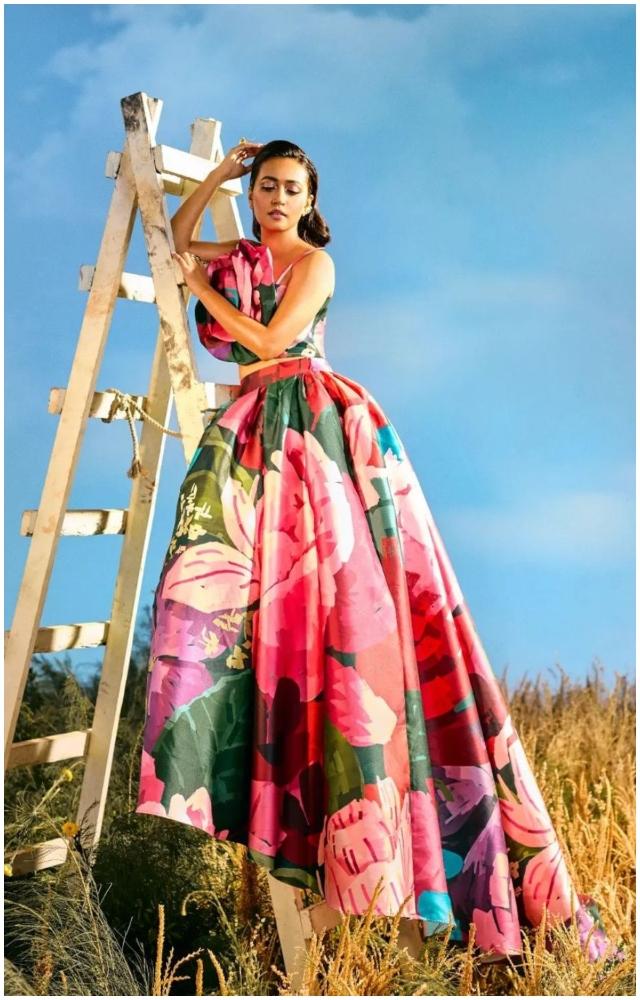 Actress Sanvikaa, who plays Rinki, is seen in an over the top floral printed gown 