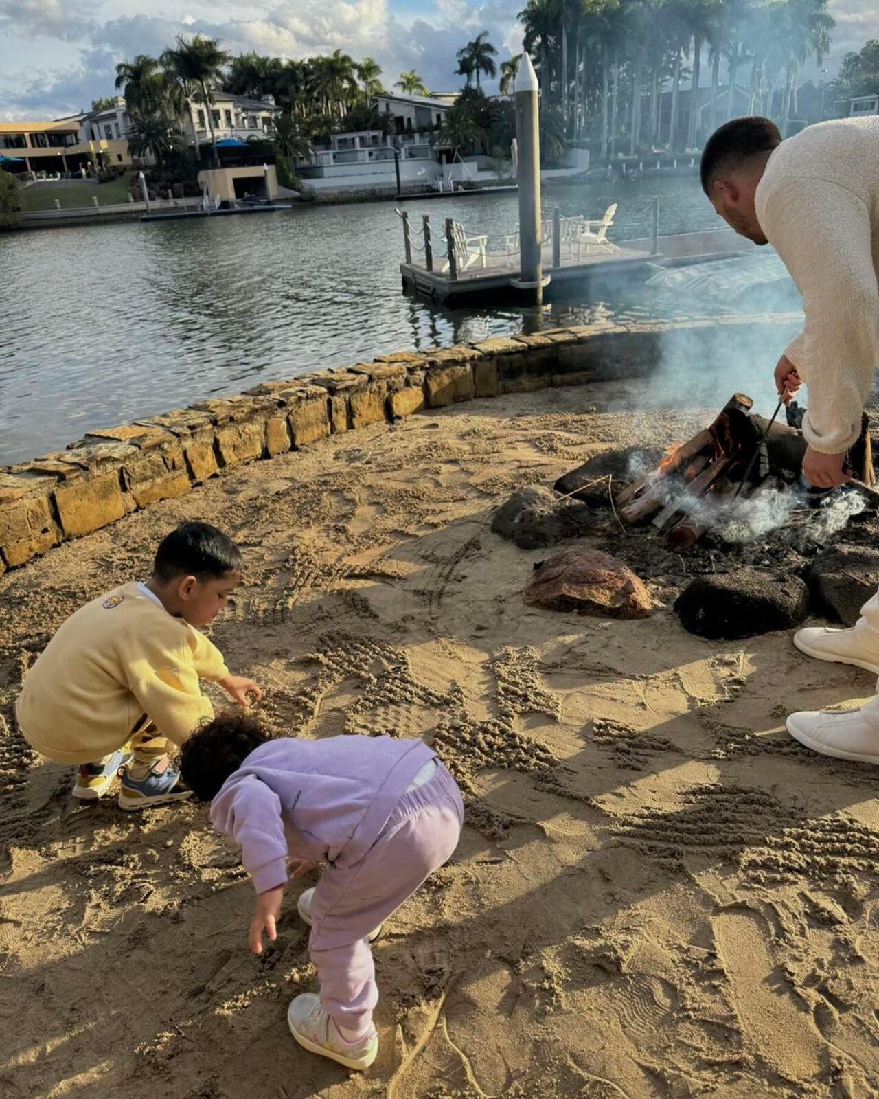 The kids enjoy beach time as the adults are busy at work