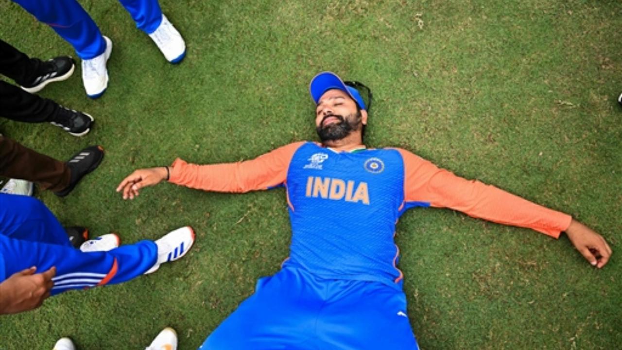 India's captain Rohit Sharma laid on the ground as he celebrates with Team India after winning the T20 World Cup 2024 final 