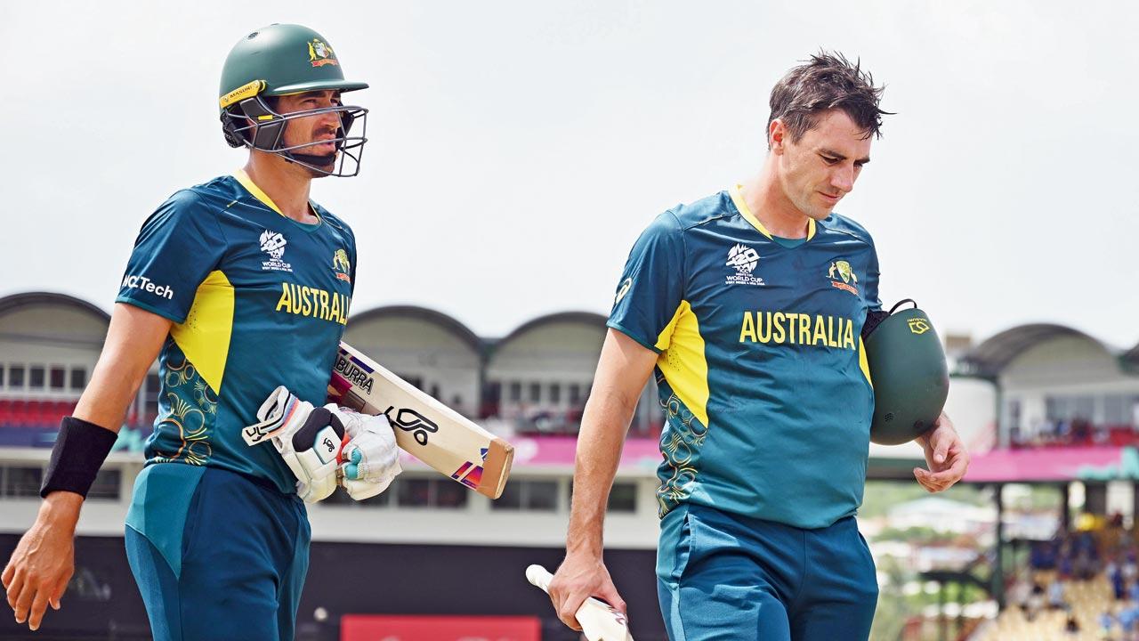 Australia’s unbeaten duo Mitchell Starc (left) and Pat Cummins  wear a dejected look after their defeat to India. Pic/Getty Images