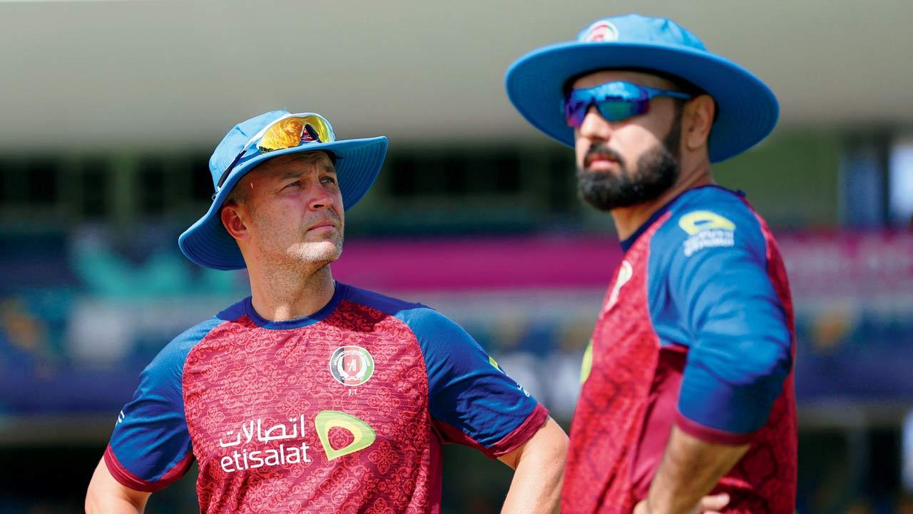 Afghanistan head coach Jonathan Trott with all-rounder Mohammad Nabi yesterday. Pic/Getty Images
