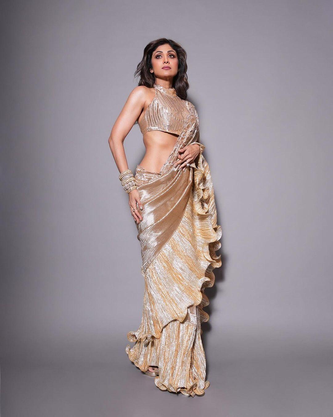 Shilpa Shetty looked stunning in a shiny rose gold saree with cute frills on the edges. 