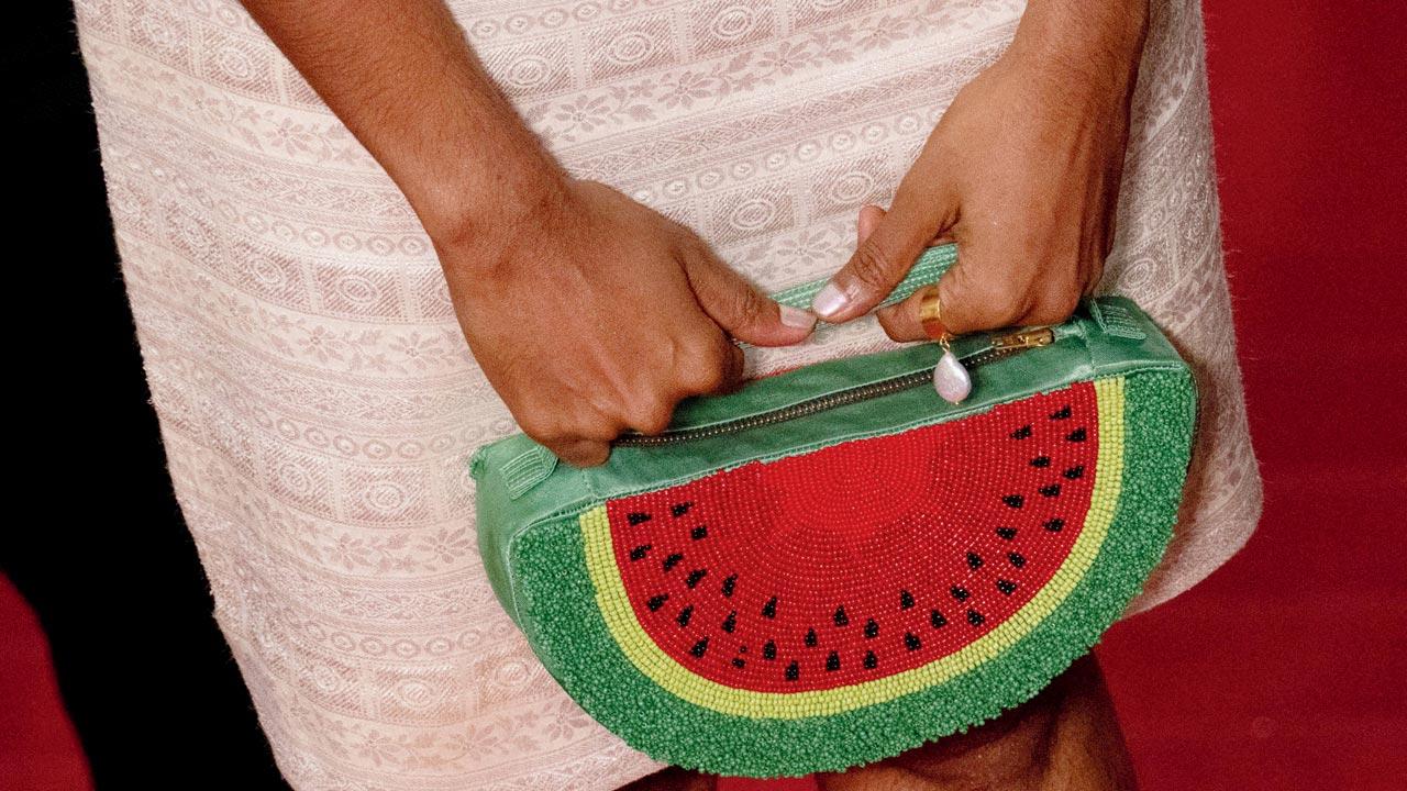 Diya John of Salt Studio designed Kani Kusruti’s clutch in the shape of a slice of watermelon using gaji silk, drawing attention to Palestine  