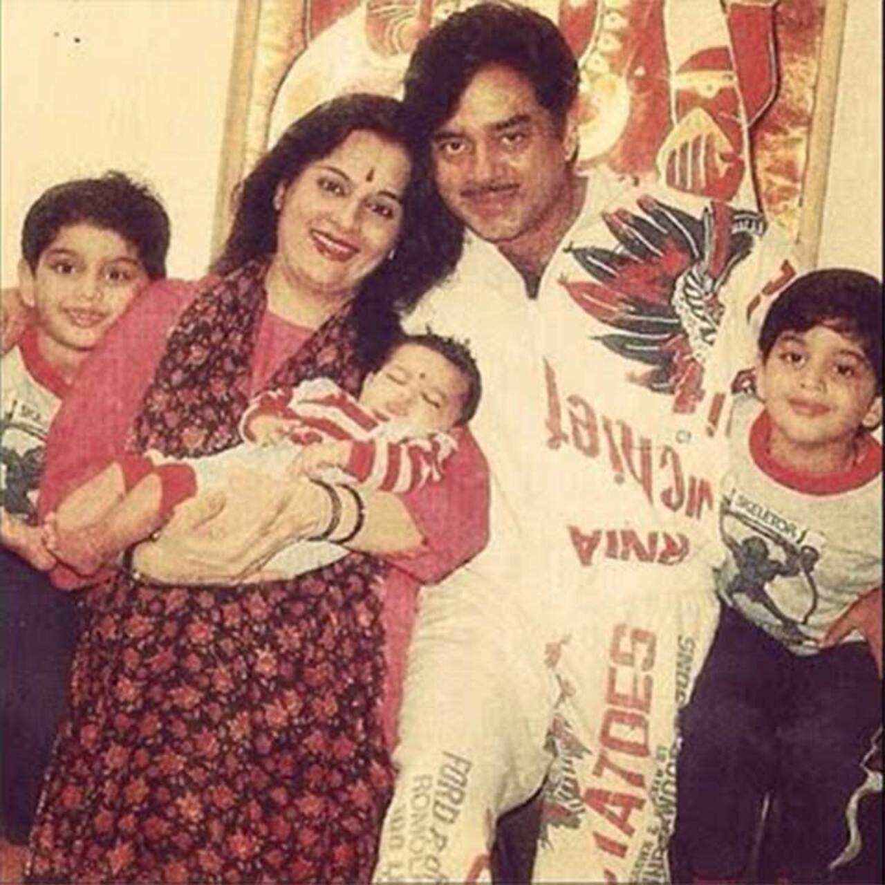 A baby Sonakshi Sinha in her mother Poonam's arms flanked by her twin brothers, Luv and Kush