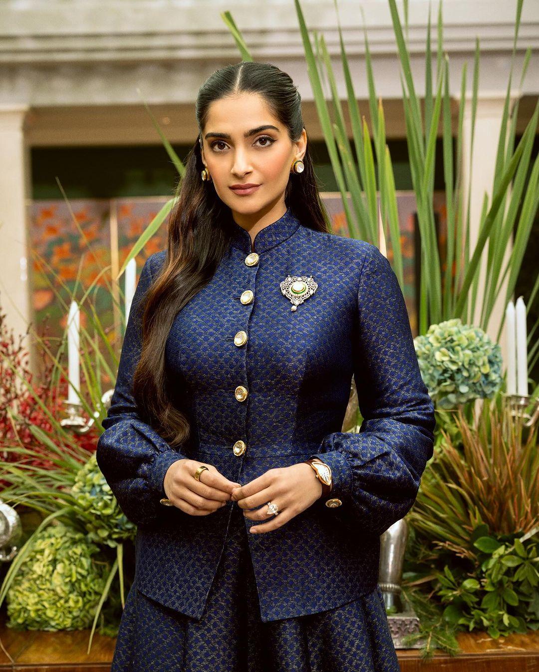 She paired it with a matching floor-length skirt. The Neerja actress completed her look with a wristwatch, rings, and bold gold earrings. 