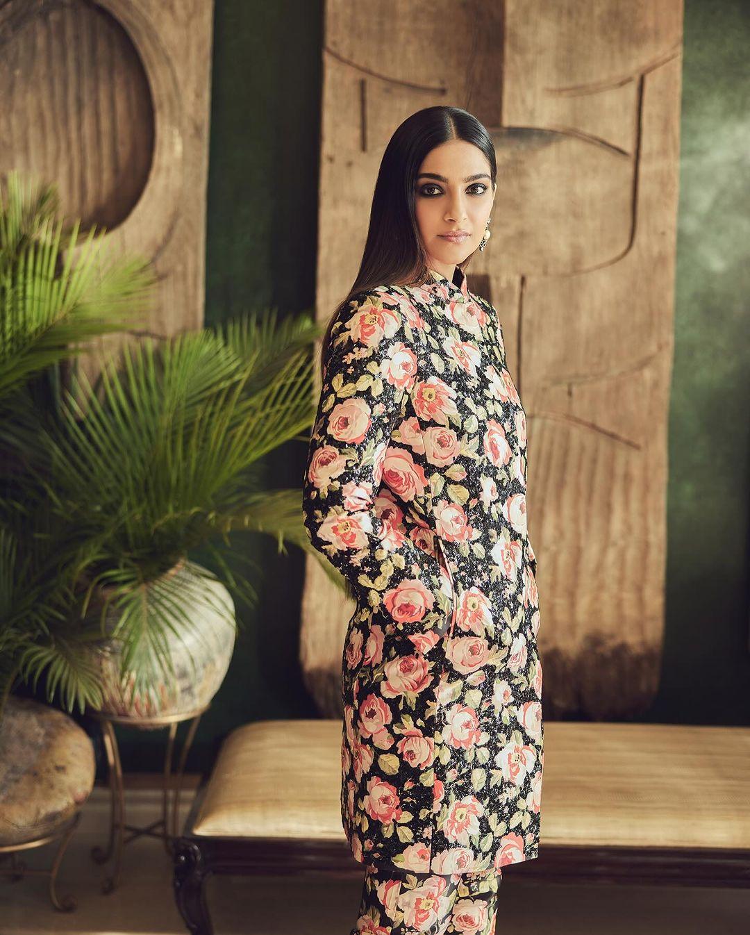 Embracing a floral theme, Sonam Kapoor wore a suit adorned with charming pink and green patterns. 