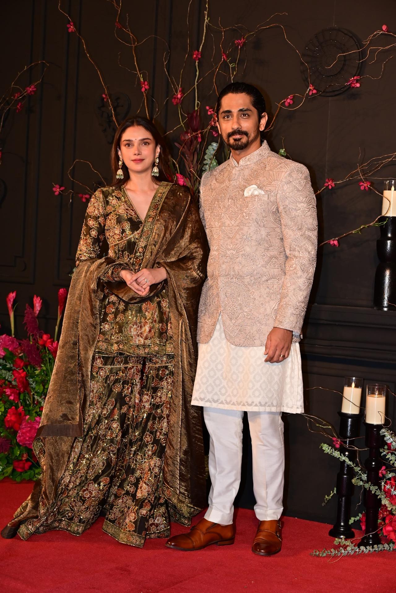 Actress Aditi Rao Hydari looked bespoke in a golden brown floral gharara set. She was accompanied by her fiance and actor Siddharth who also looked dashing in a mauve bandhgala set. 