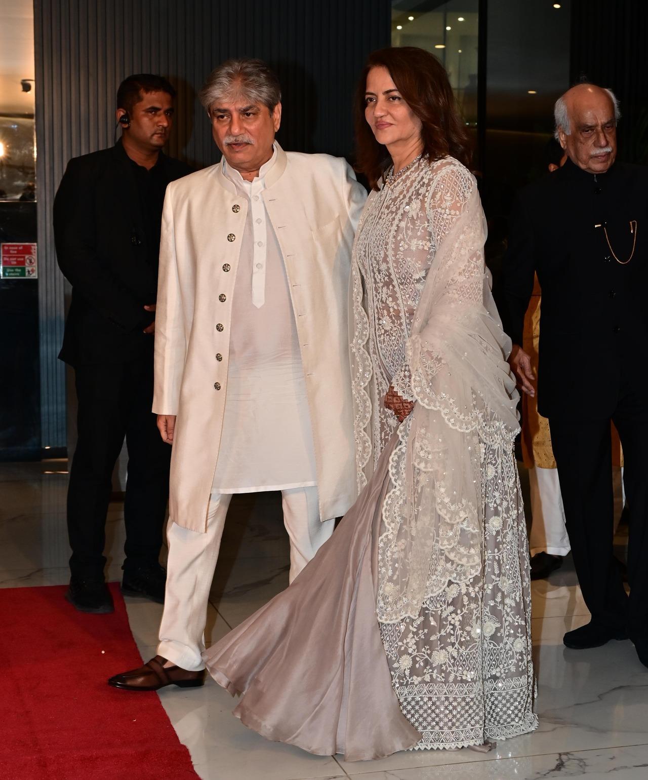Zaheer’s parents twinned in white as they posed happily for the paparazzi stationed outside. 