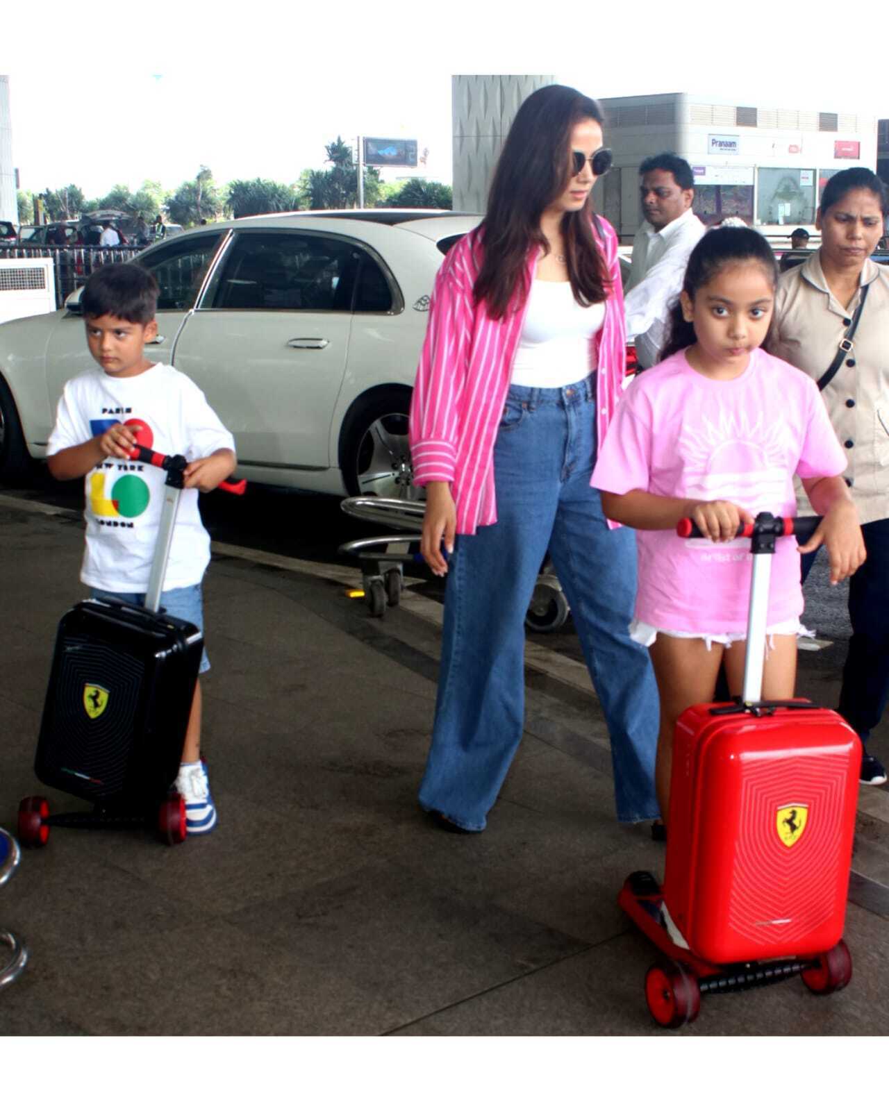 Mira was seen managing her kids as they were busy playing around the airport premise with their bags