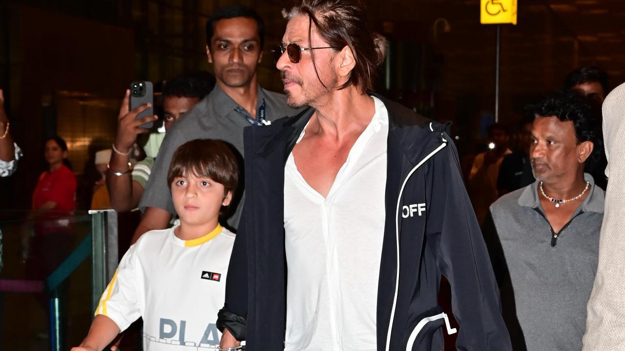 Don't miss this! Shah Rukh Khan holds AbRam's hand at airport, watch video