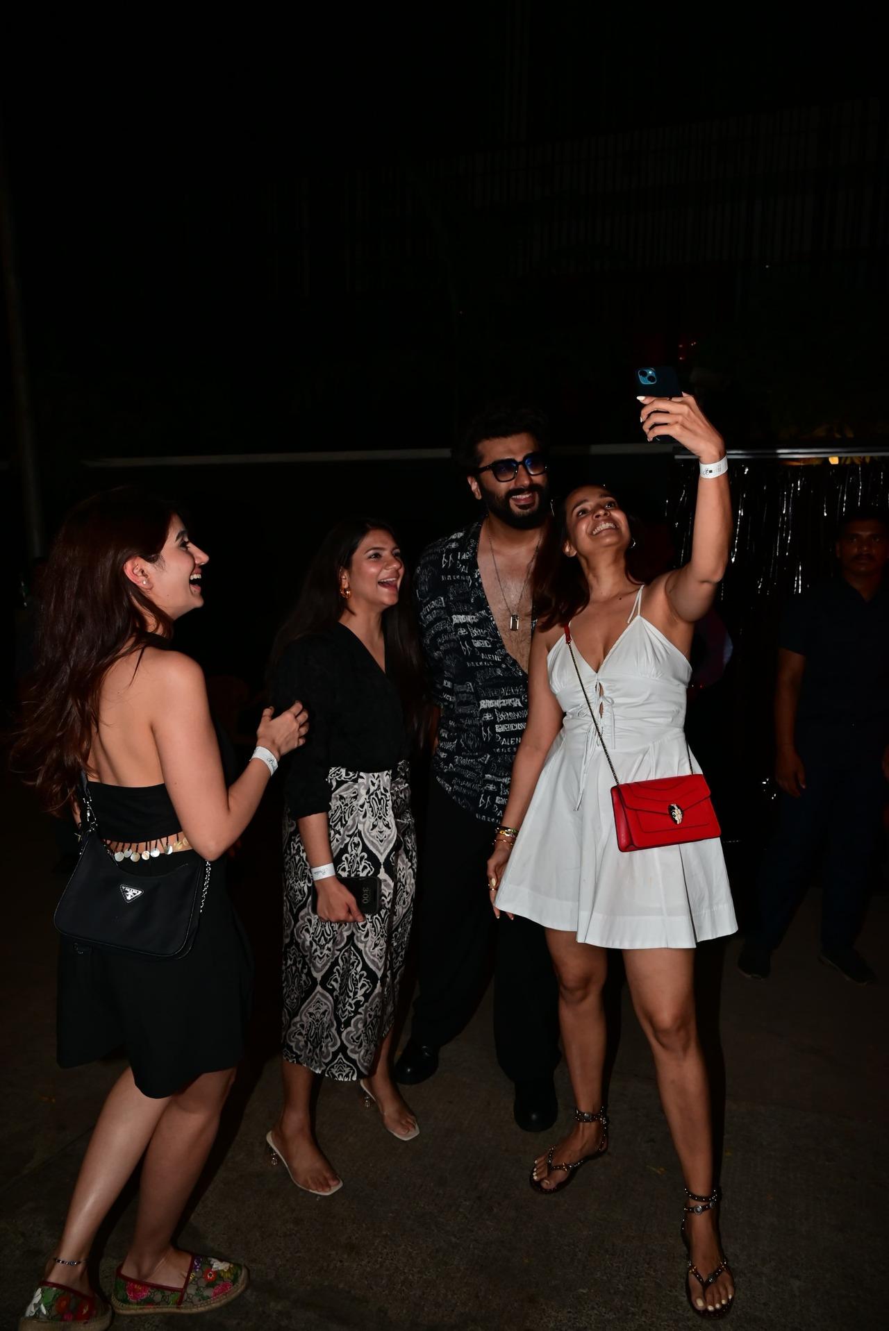 Arjun Kapoor happily poses with fans outside the party venue