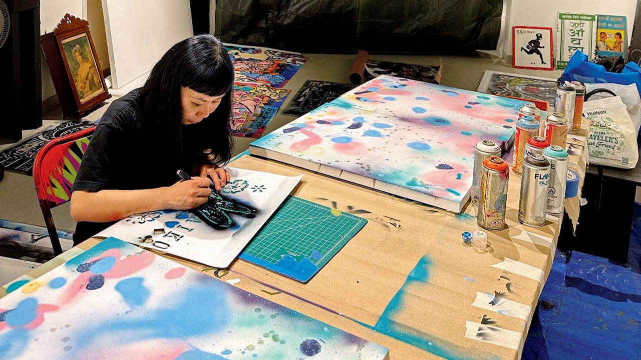 The artist works on an artwork in the studio