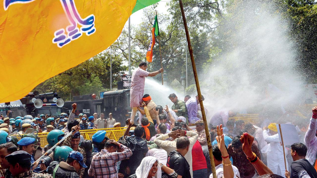 Security personnel use water cannon to disperse BJP workers. Pic/PTI 