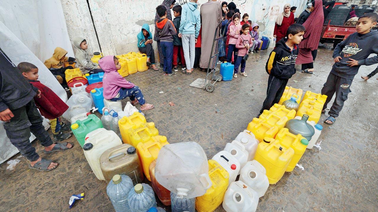 Palestinian children wait to fetch water in Rafah. Pic/AP