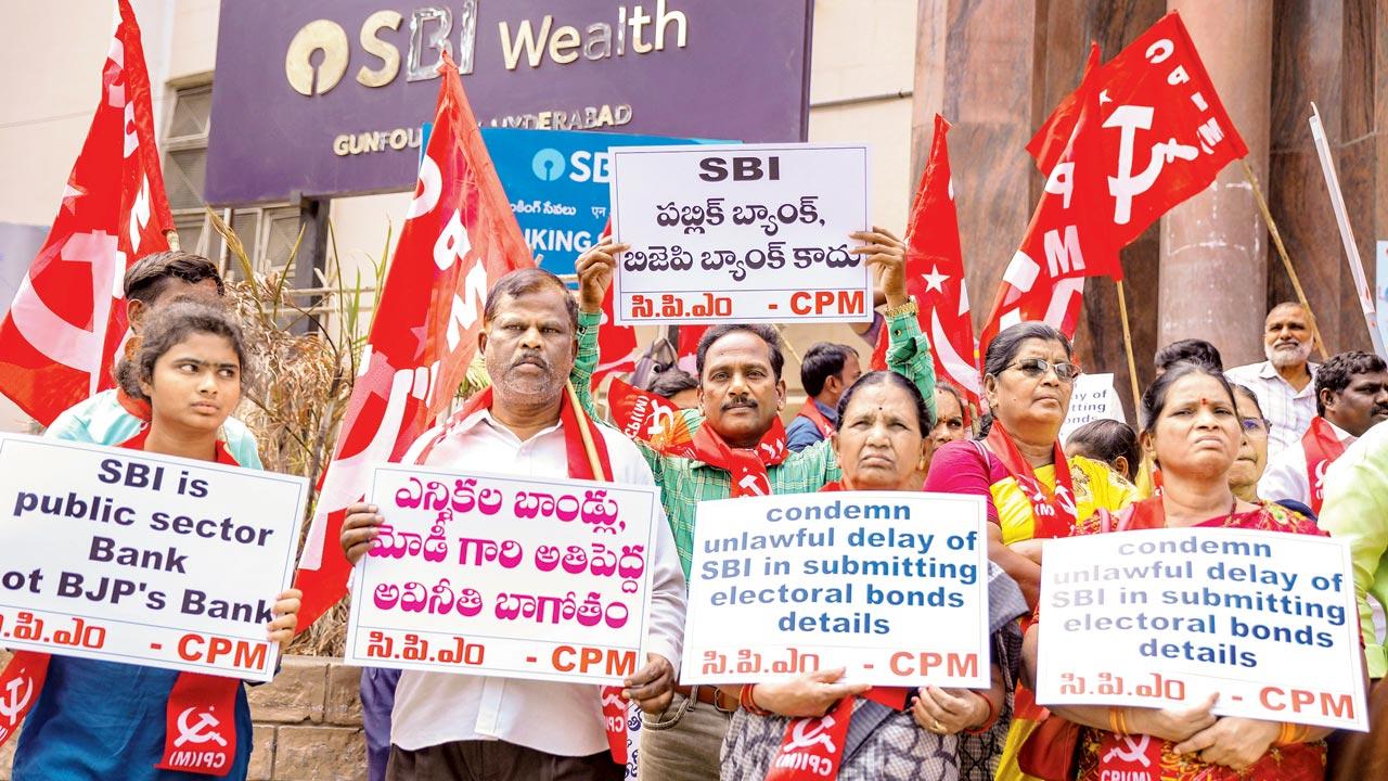 CPM activists stage a protest outside a branch of SBI. Pics/PTI  