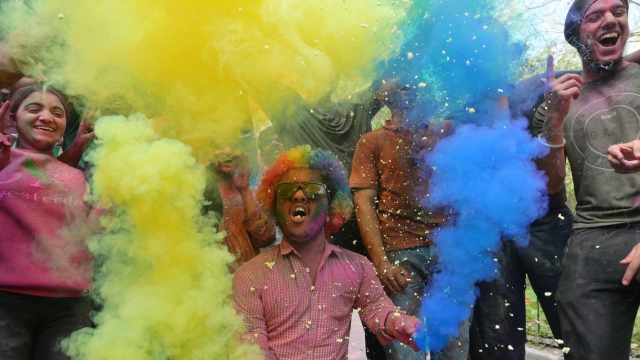 The following day, streets and residences come alive with bursts of color as people join in passionate 'Rangwali Holi,' smearing one other with vivid gulal (colored powder) and dousing one another with water-filled balloons