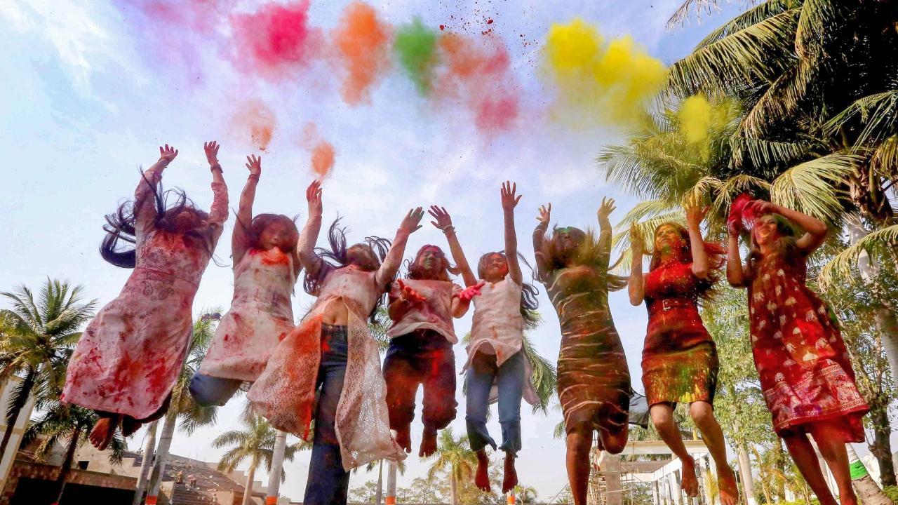 Young women drenched in colours celebrate Holi in Bhopal on Friday. Pics/PTI and AFP