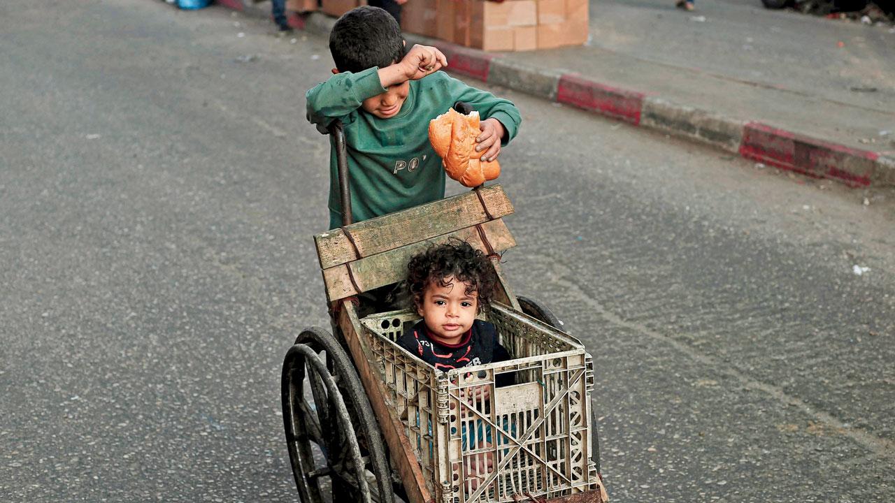 Displaced Palestinians line up for fresh bread in Rafah
