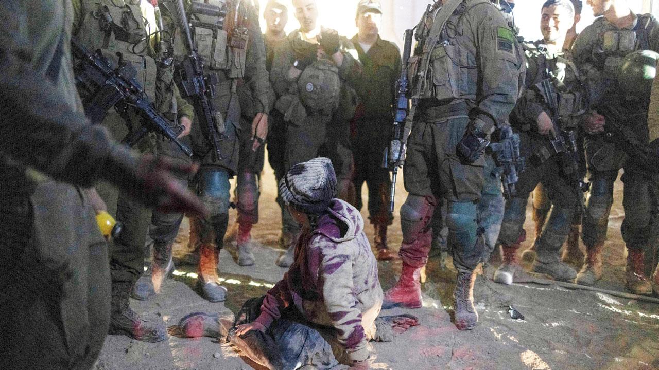 A female right wing activist falls to the ground during scuffles with Israeli troops near the Erez crossing