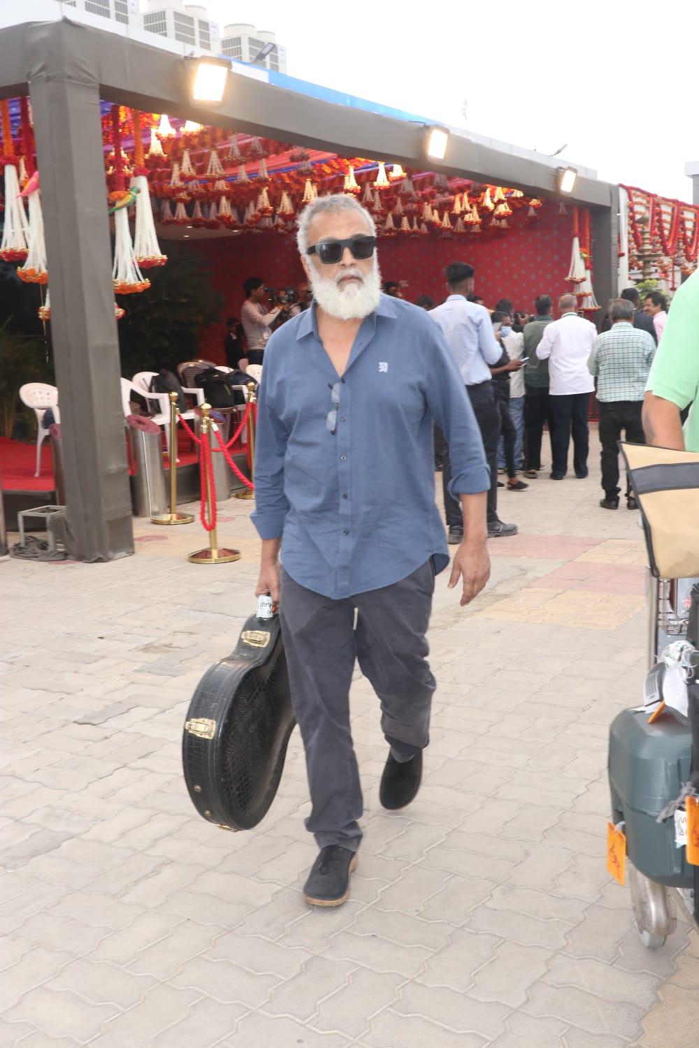 Pop star Lucky Ali was clicked at the Jamnagar airport with his Guitar