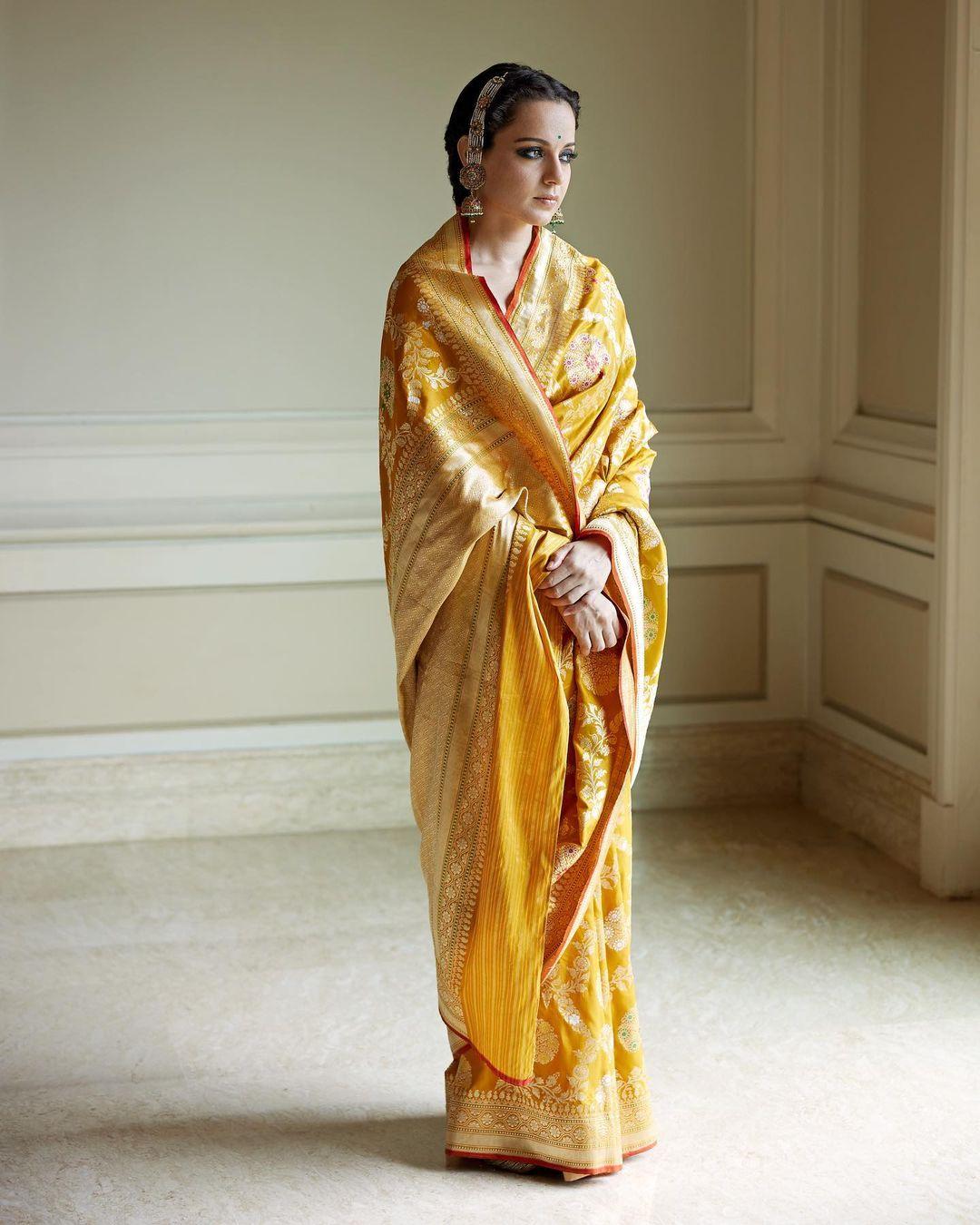 Wondering how to style a saree to look stunning? Take cues from Kangana Ranaut. The actress wore a beautiful Banarasi yellow saree with contrasting green and red designs on it