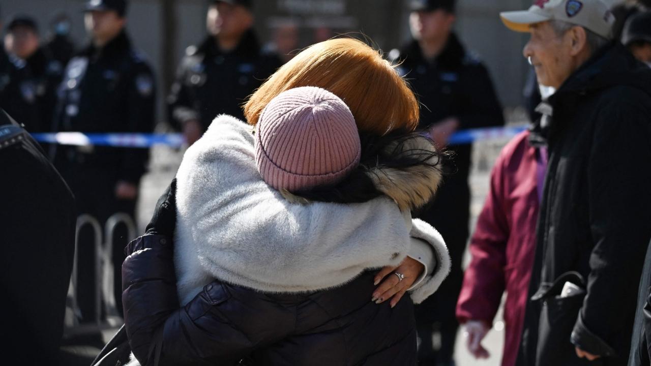 Relatives of passengers on board the missing Malaysian Airlines flight MH370 embrace during a gathering outside the Malaysian embassy in Beijing. Pics/AFP (Text/AP)