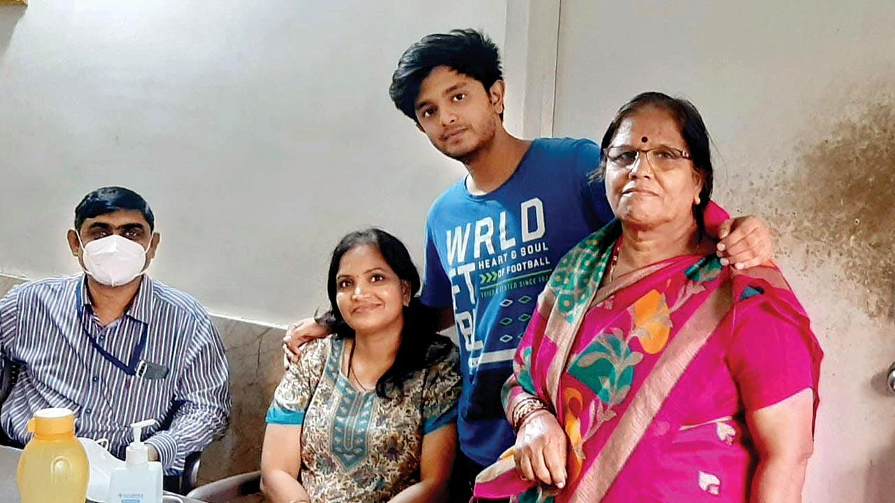 Sushant Satpute (in blue) with his mother Suvarna (seated) and grandmother shortly before his arrest 