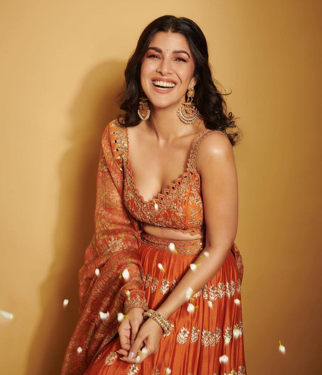 She styled her hair in a stylish hairstyle and ditched heavy jewellery, opting for intricate heavy earrings to finish her look