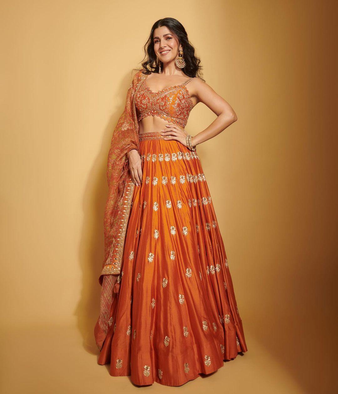 Oh my god, this orange lehenga set is just taking our breath away