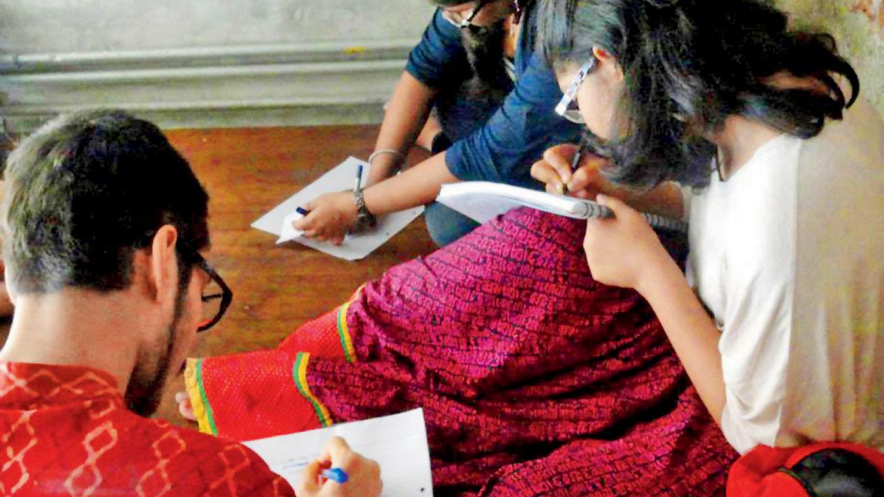 Young poets scribble poems together at a Bandra café