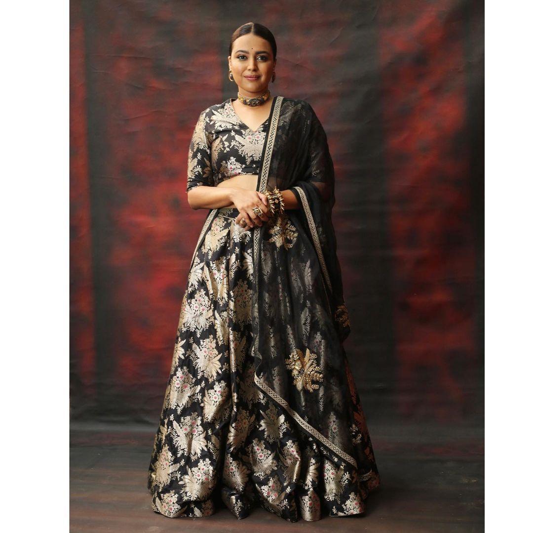 Swara Bhaskar's look is just wow. The actress wore a beautiful black lehenga with golden prints on it. She paired it with a sheer dupatta. Swara tied her hair in a chic bun and wore a nice choker. She also wore stud earrings to finish her look. She put on an intricate bangle to maintain a balance in her appearance