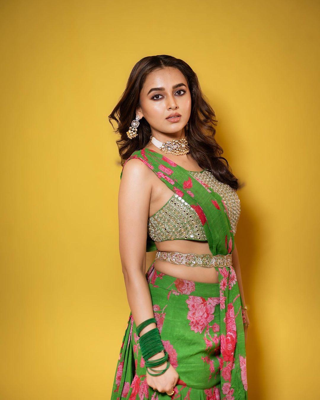 With velvet bangles, hair styled in loose curls, and minimal makeup, Tejasswi stole hearts. Further, she wore big earrings and a stylish necklace, which made this look one of our favourites of all