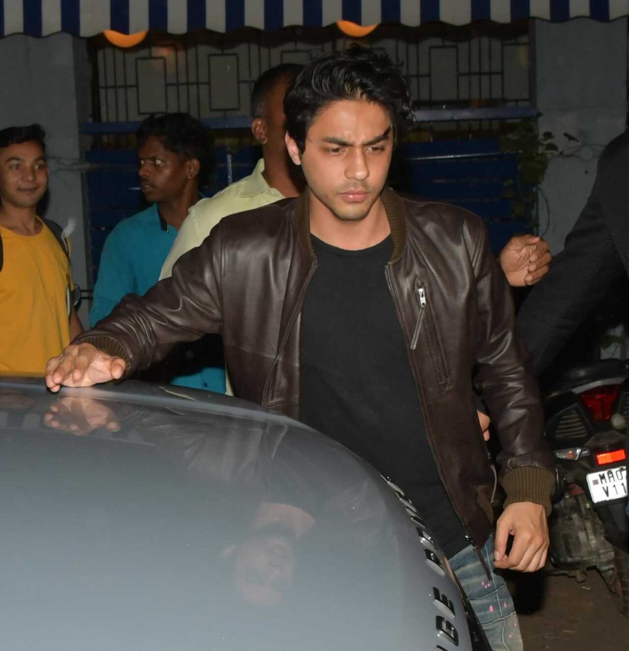Superstar Shah Rukh Khan's son Aryan Khan arrived in style wearing a black t-shirt, grey pants and a brown leather jacket. 