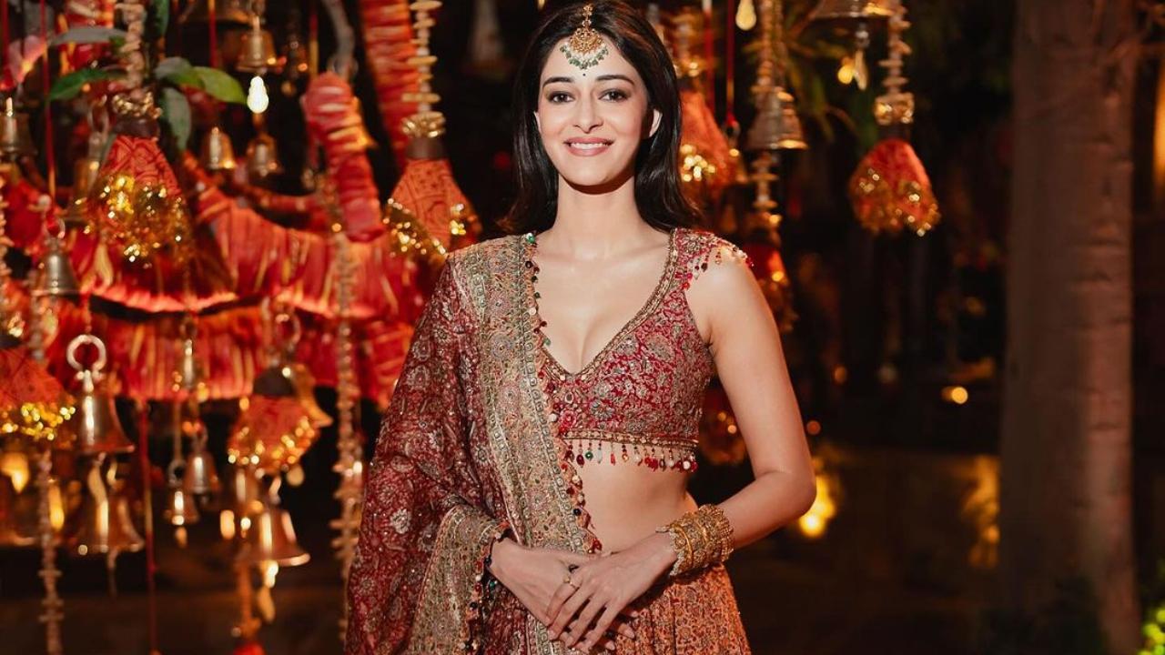 Ananya Panday wore a maroon and rust shade lehenga that was heavily embellished with sequins. She accessorised it with a maang tika. 