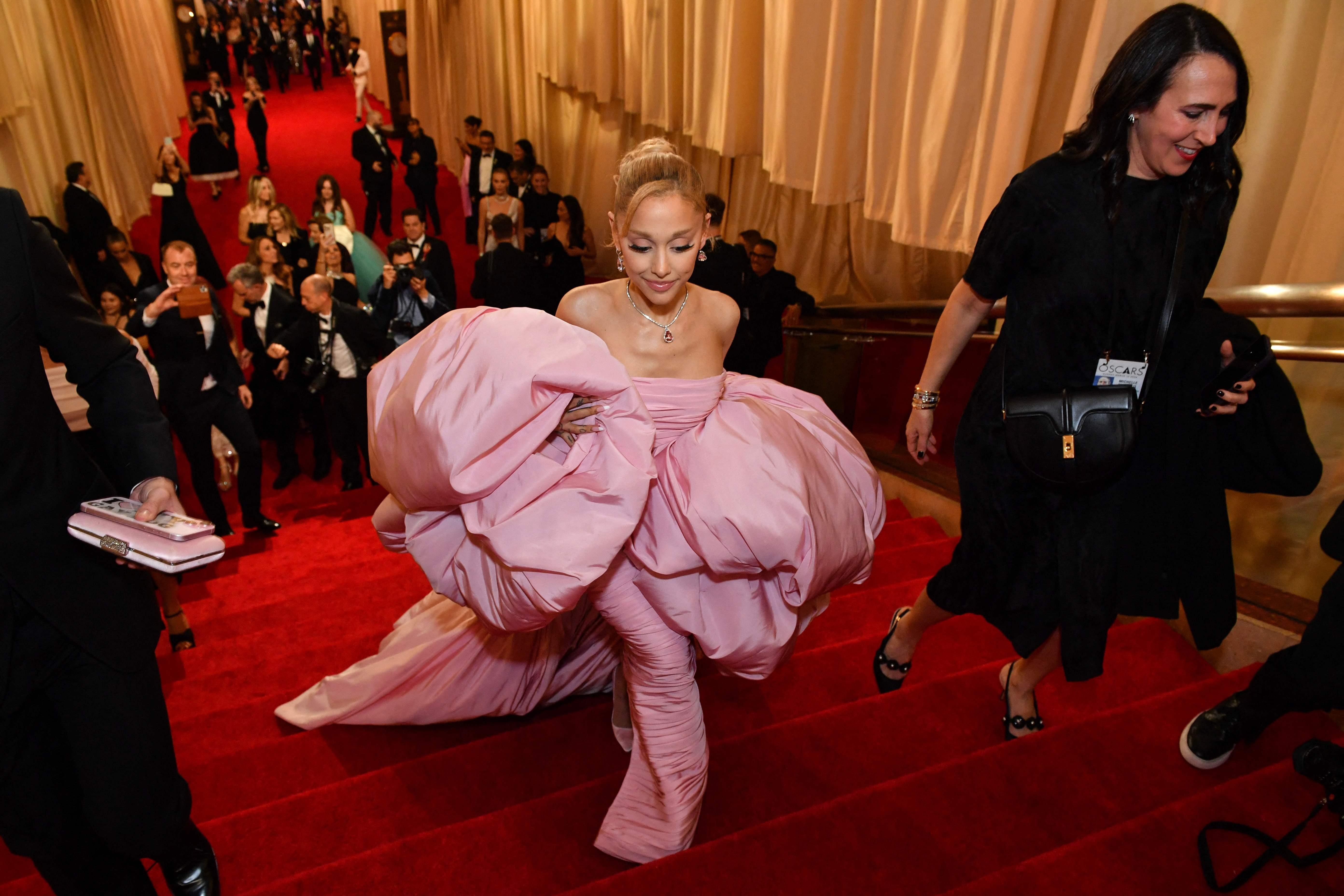Ariana Grande had a quick turnaround from performing on Saturday Night Live to presenting at the Oscars the next evening. The singer and Wicked actress graced the red carpet in a striking pink bubble dress designed by Giambattista Valli, paying homage to her character Glinda. 