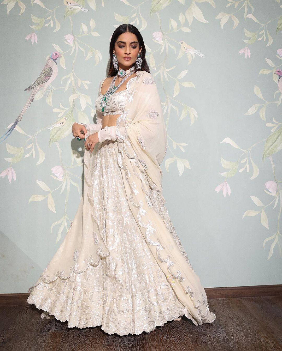 Sonam Kapoor's look from the Mela Rouge was all things royal. Kapoor exuded grace and sophistication in a stunning white gown crafted by the renowned designer Anamika Khanna. What truly elevated her ensemble was Sonam's choice of jewellery. She adorned herself with exquisite silver-green accessories, including elegant necklaces, and elongated earrings