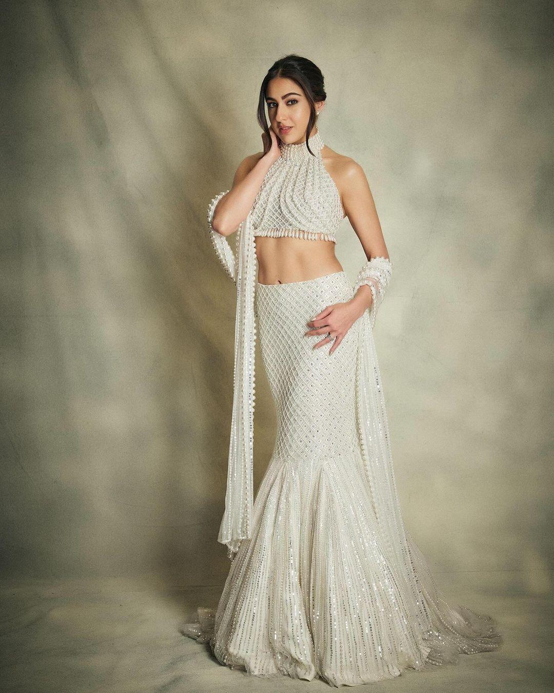 Sara Ali Khan's day 1 look may have been disappointing, but she skillfully redeemed herself at the Mela Rogue. Opting for a breathtaking white ensemble designed by Manish Malhotra, the actress adorned a pearl-beaded blouse paired elegantly with a fishtail long skirt. She elevated the look by styling her hair in a chic bun and opting for light, yet radiant makeup, enhancing her overall appearance