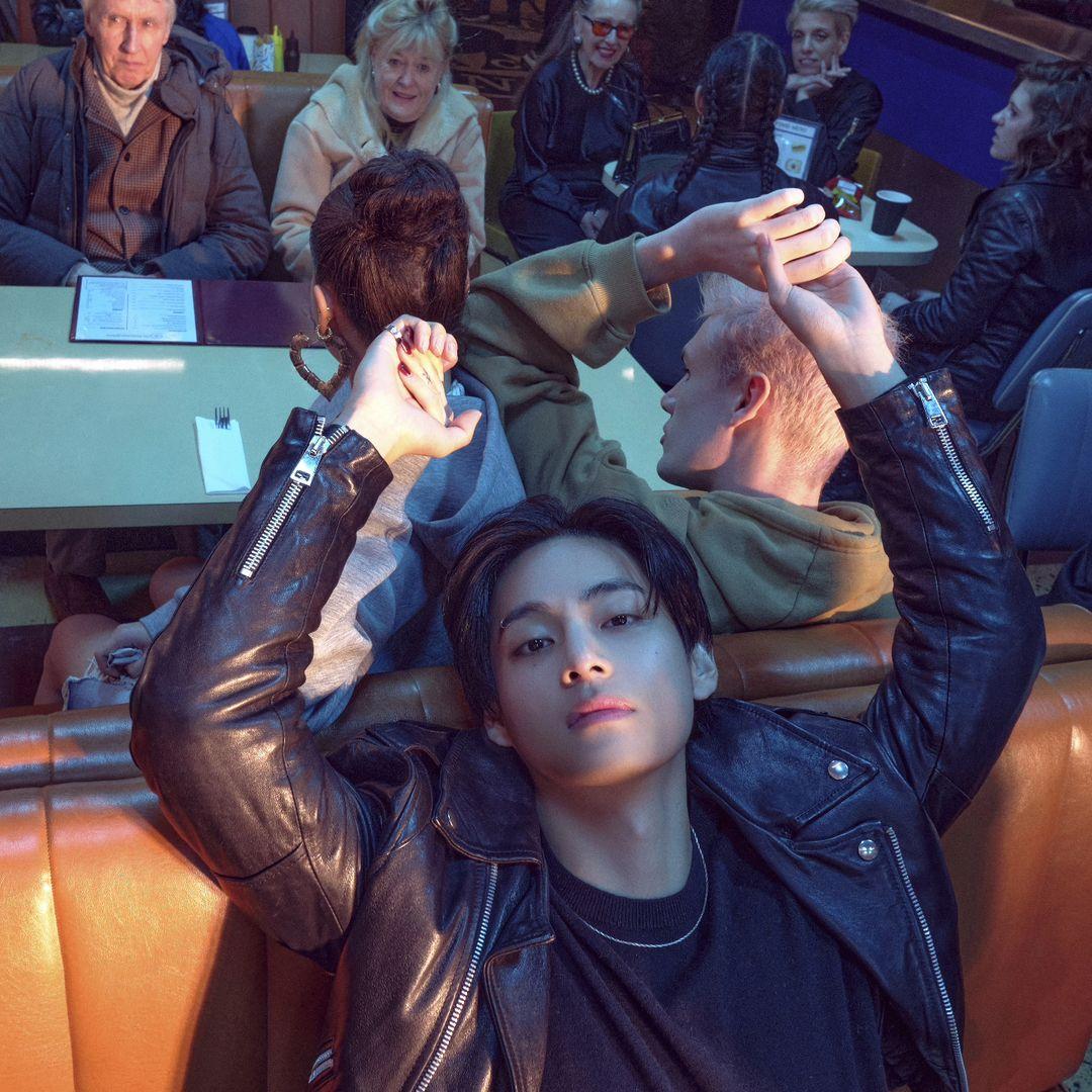 Serving grunge looks on a platter, V is seen lounging in a leather jacket as he focuses on the camera