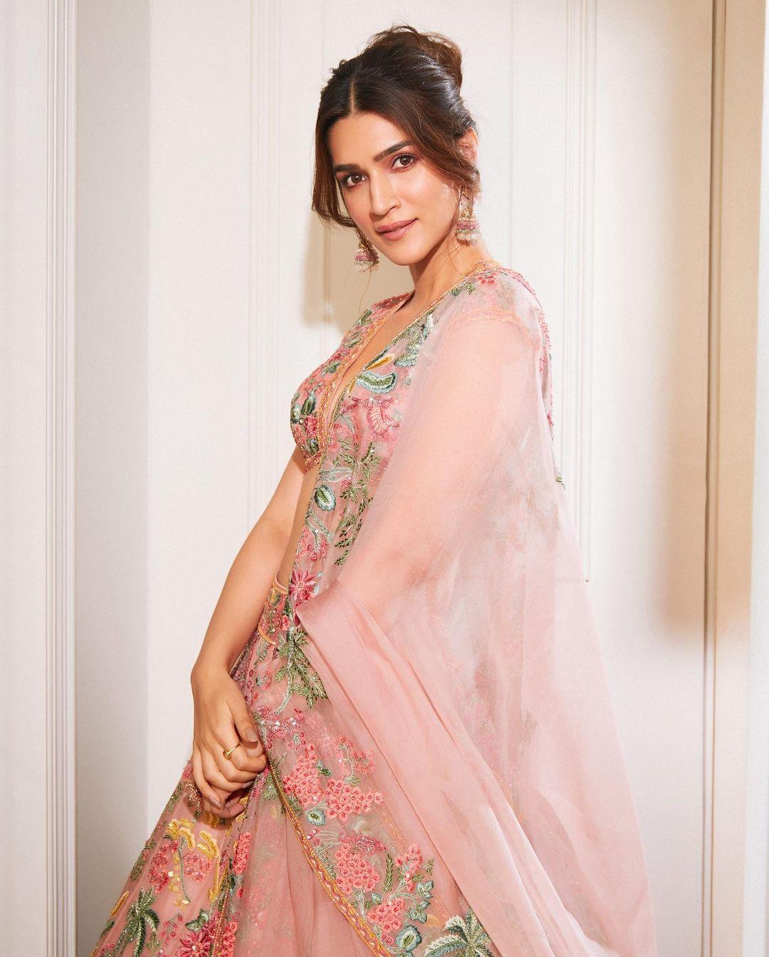It is Holi, and of course, you want to wear something colorful; worry not, we got you covered. In this look, Kriti wore a stunning pink lehenga with colourful embroidery on it