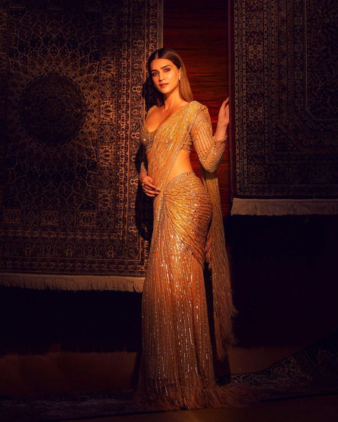 In yet another appearance, Kriti Sanon aced her look, and this is a must-have outfit if you are going to a friend's place for Holika Dahan. The actress wore a stunning golden saree and paired it with a matching blouse