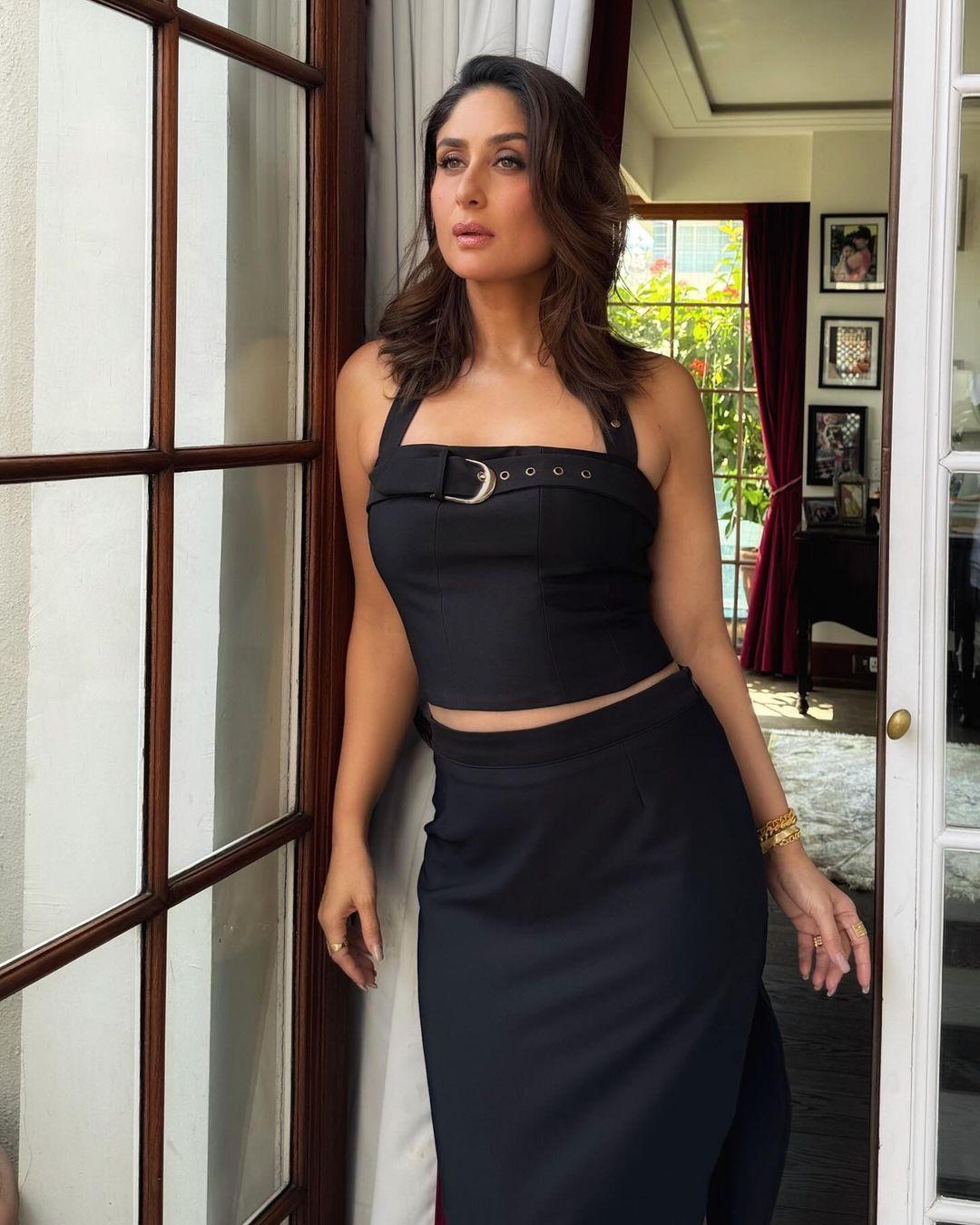Not even letting us breathe, Kareena wore a stylish black strappy crop top with a long skirt