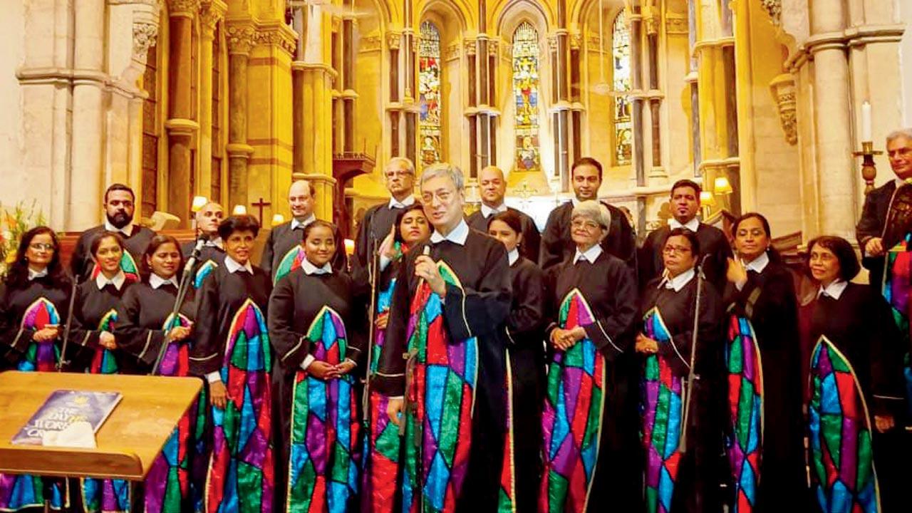 The choir, conducted by (centre) Alfred D’Souza, will perform in their famous stained glass window robes