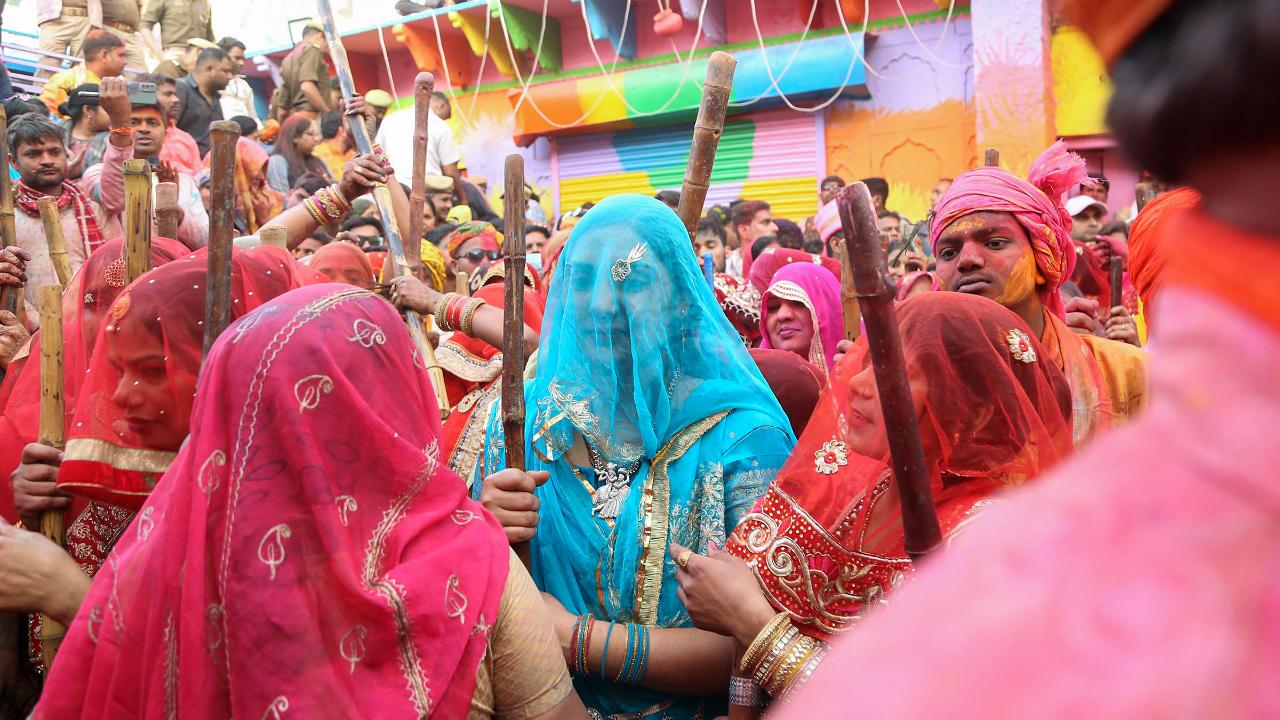 People partake in the Lathmar Holi celebrations at Nandgaon, in Mathura district. Lathmar Holi is a unique Indian celebration where women playfully beat men with sticks, symbolising the legendary interaction between Lord Krishna and Radha. This traditional event is filled with laughter, music and vibrant colours, showcasing the joyous spirit of Holi