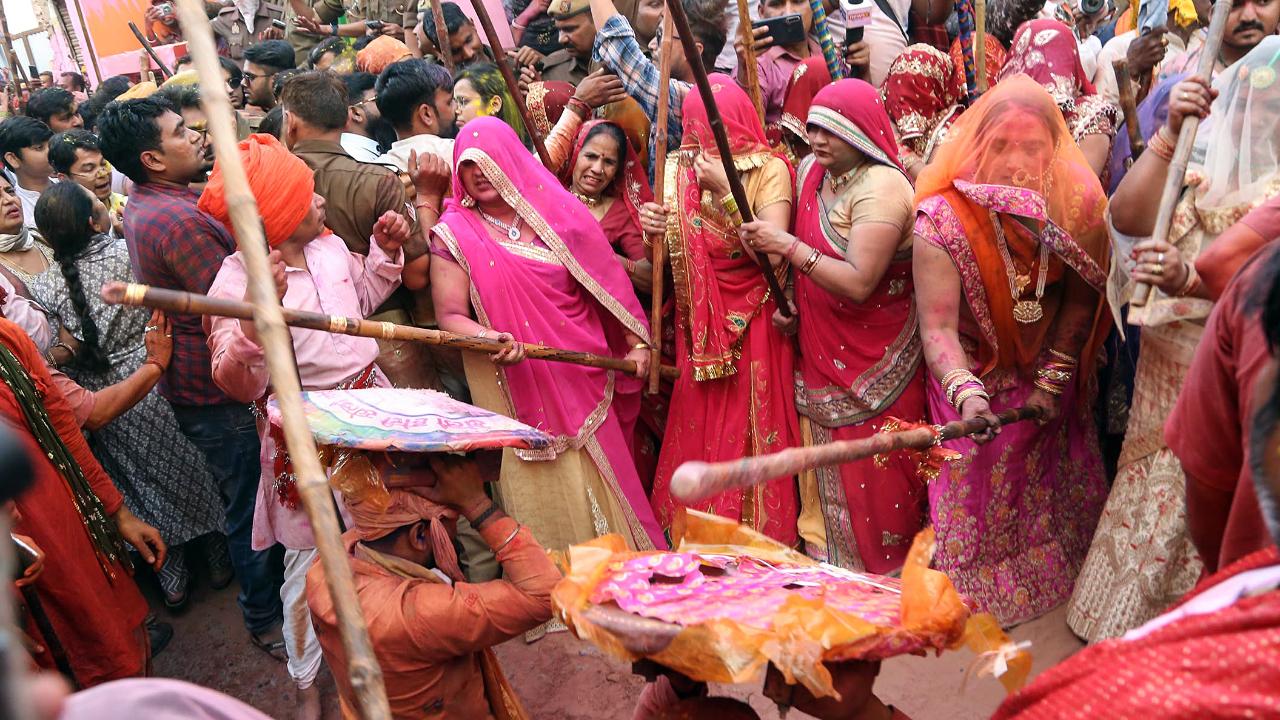 Lathmar Holi is a unique Indian celebration where women playfully beat men with sticks, symbolising the legendary interaction between Lord Krishna and Radha. This traditional event is filled with laughter, music and vibrant colours, showcasing the joyous spirit of Holi