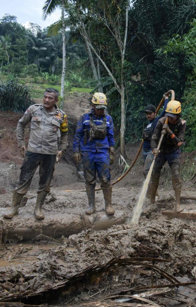 At least nine Indonesians were reported missing overnight after the landslide and flooding in the village