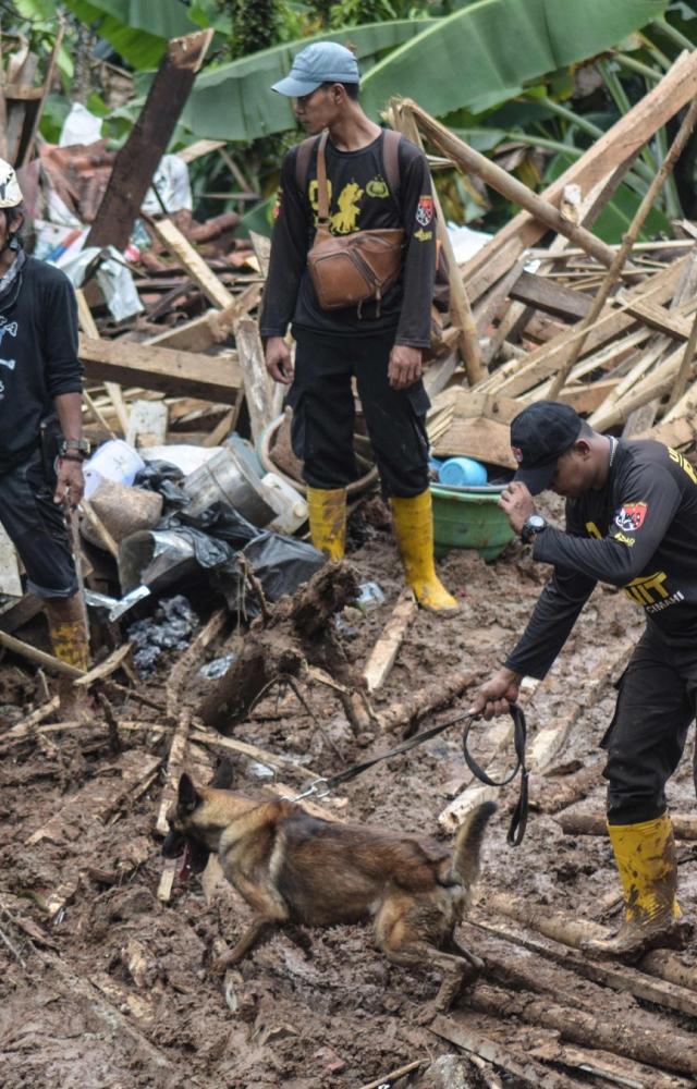 A landslide and flooding hit a village on Java island in Indonesia, an official said on March 25